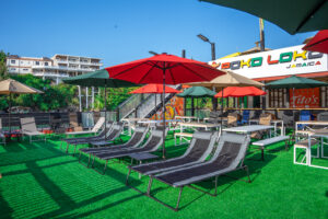 Outdoor lounge area with colorful umbrellas.